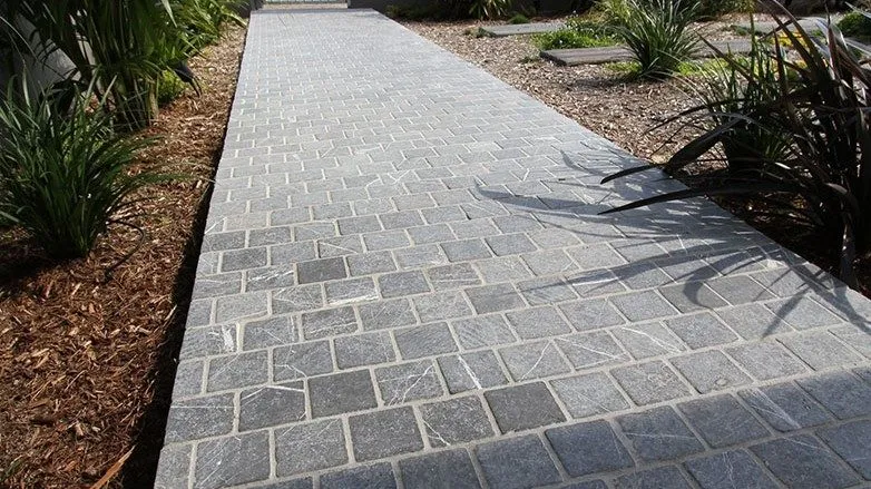 Classic cobblestone walkway with garden planting